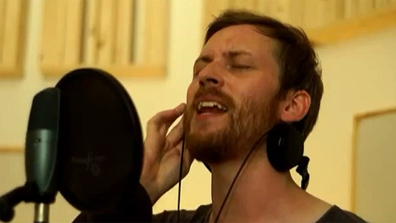 Ein Mann singt in ein Mikrofon (LeStereo)  
