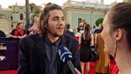 Portugals Teilnehmer Salvador Sobral gibt am roten Teppich bei der ESC-Eröffnung ein Interview. © NDR 